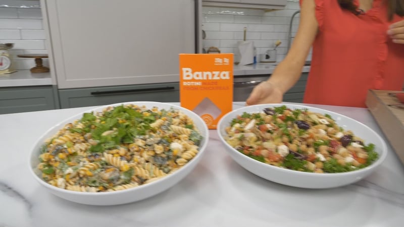 Two bowls of summer pasta salads are shown on a table.