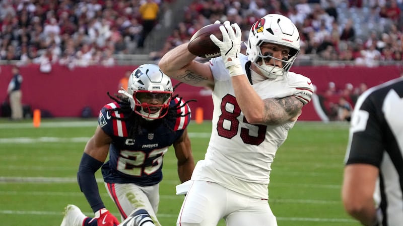 Arizona Cardinals tight end Trey McBride (85) makes a catch as New England Patriots safety...