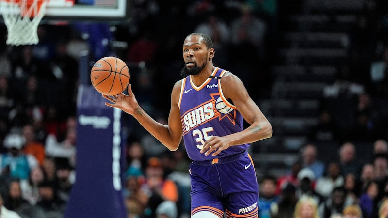 Phoenix Suns forward Kevin Durant (35) brings the ball up court against the Charlotte Hornets...