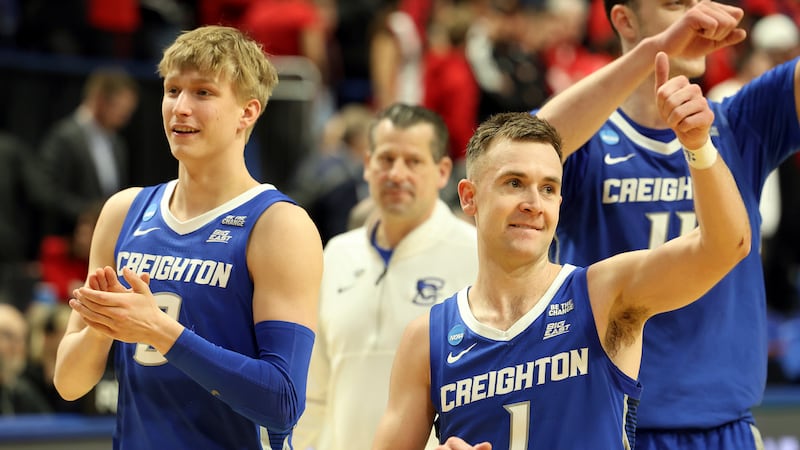 Creighton's Ty Davis, left, and Steven Ashworth (1) leave the floor after defeating Louisville...