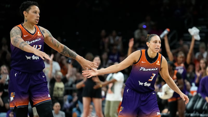 FILE - Phoenix Mercury center Brittney Griner, left, celebrates a score by guard Diana Taurasi...