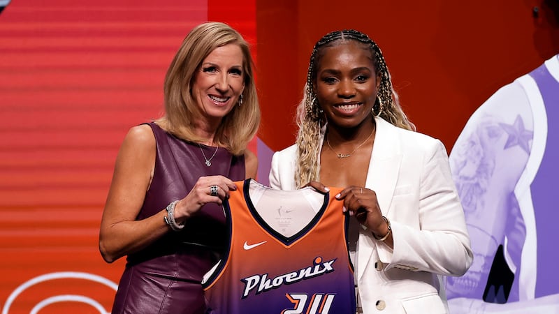 UCLA's Charisma Osborne, right, poses for a photo with WNBA commissioner Cathy Engelbert,...