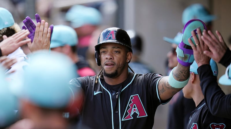 Arizona Diamondbacks' Ketel Marte celebrates after scoring against the Chicago Cubs during the...