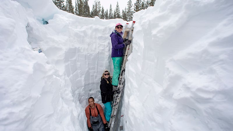 FILE - Working inside a nearly 18-foot-deep snow pit at the UC Berkeley Central Sierra Snow...