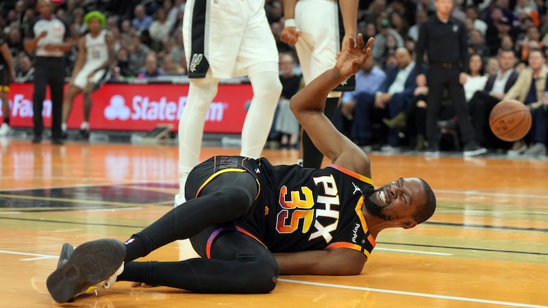 Phoenix Suns forward Kevin Durant reacts after falling to the floor against the San Antonio...