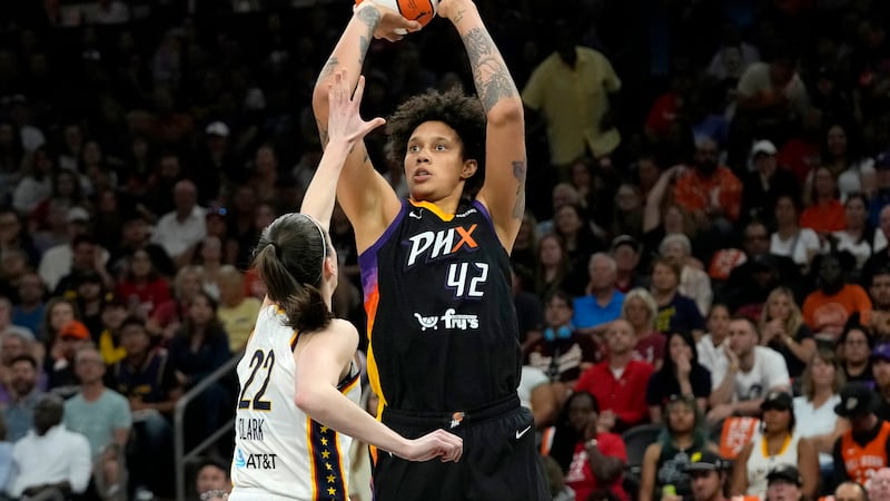 Phoenix Mercury center Brittney Griner (42) looks to shoot over Indiana Fever guard Caitlin...