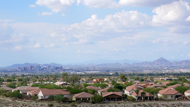 FILE - With the downtown skyline in the background, expansive urban sprawl continues to grow,...