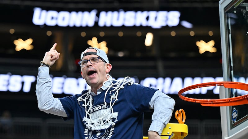 UConn head coach Dan Hurley celebrates after cutting down the netting from the 82-54 win...
