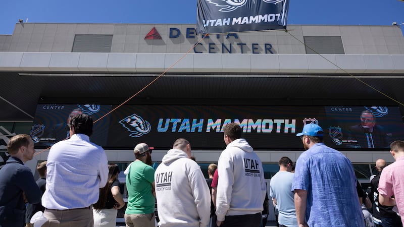 Fans watch outside Delta Center watch the live press conference announcing Utah Mammoth as the...