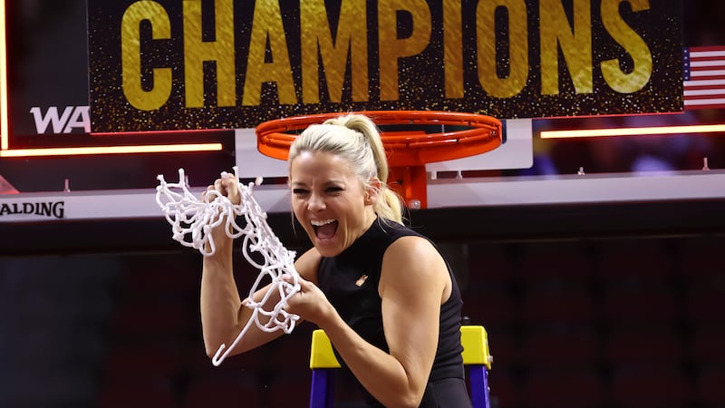 Grand Canyon head coach Molly Miller cuts down the net after the team's victory over...