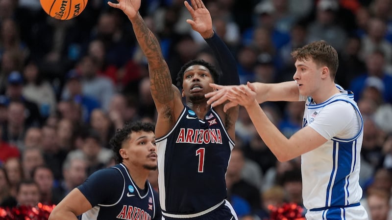 Duke forward Cooper Flagg (2) passes against Arizona guard Caleb Love (1) during the first...