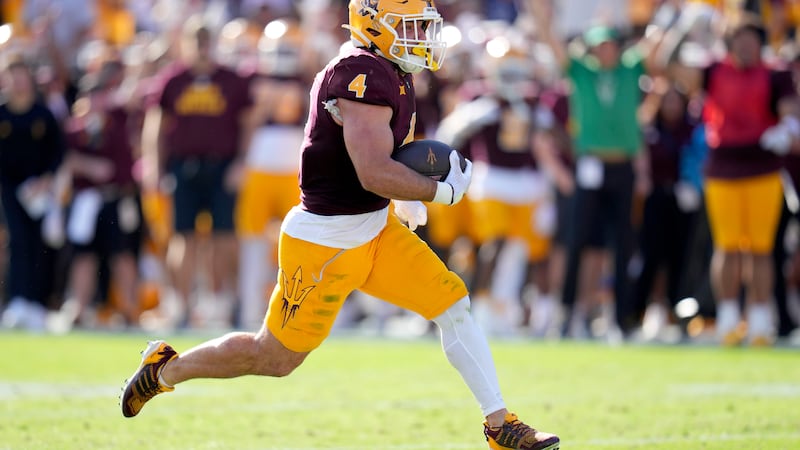 Arizona State running back Cam Skattebo runs for a touchdown against BYU during the first half...