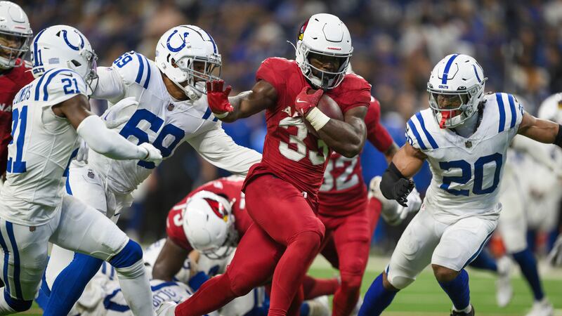 Arizona Cardinals running back Trey Benson (33) breaks a run up the middle against...