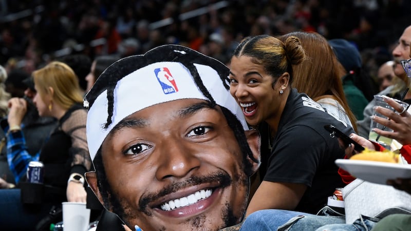 Kamiah Adams-Beal holds a photo of her husband, Washington Wizards guard Bradley Beal, during...