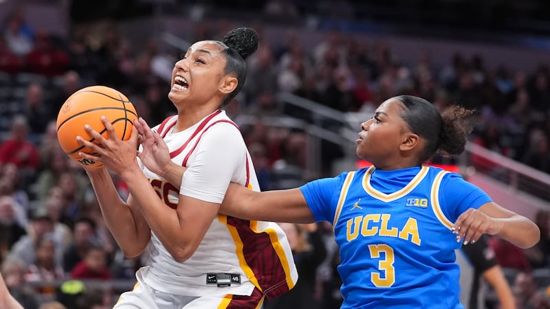 Southern California guard JuJu Watkins, left, grabs a rebound from UCLA guard Londynn Jones...