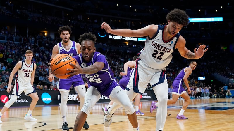 Grand Canyon guard Josh Baker, left, pulls in the ball as Gonzaga forward Anton Watson defends...