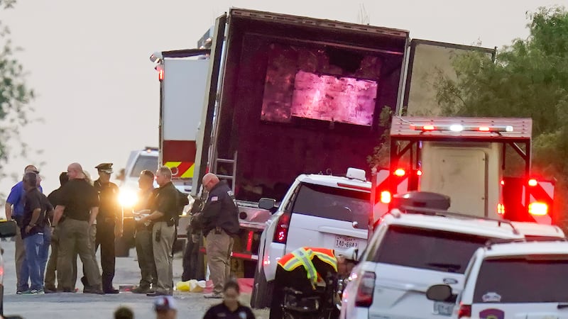Police and other first responders work the scene where officials say dozens of people have...