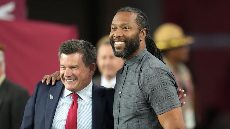 Arizona Cardinals owner Michael Bidwill, left, gets a hug from former Cardinals wide receiver...