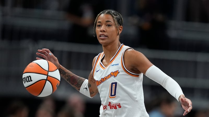 Phoenix Mercury's Natasha Cloud dribbles during the first half of a WNBA basketball game...