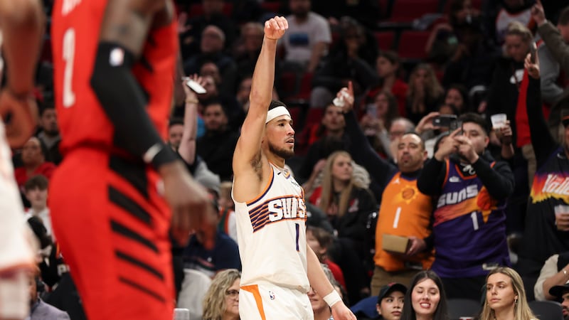 Phoenix Suns guard Devin Booker (1) reacts after scoring against the Portland Trail Blazers to...