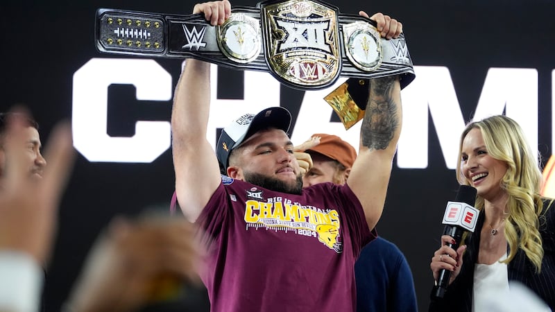 Arizona State running back Cam Skattebo (4) holds up the most valuable player trophy after the...