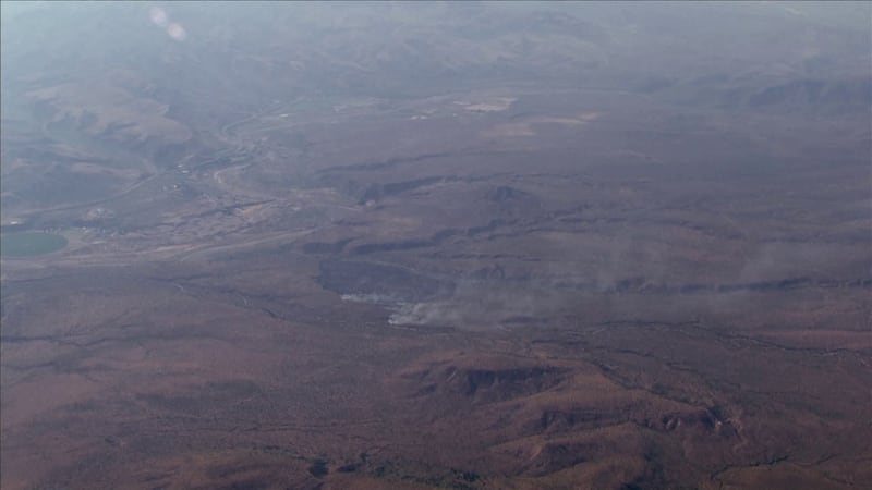 Crews say the hot weather and steep, rugged terrain in that forest are making tackling a...