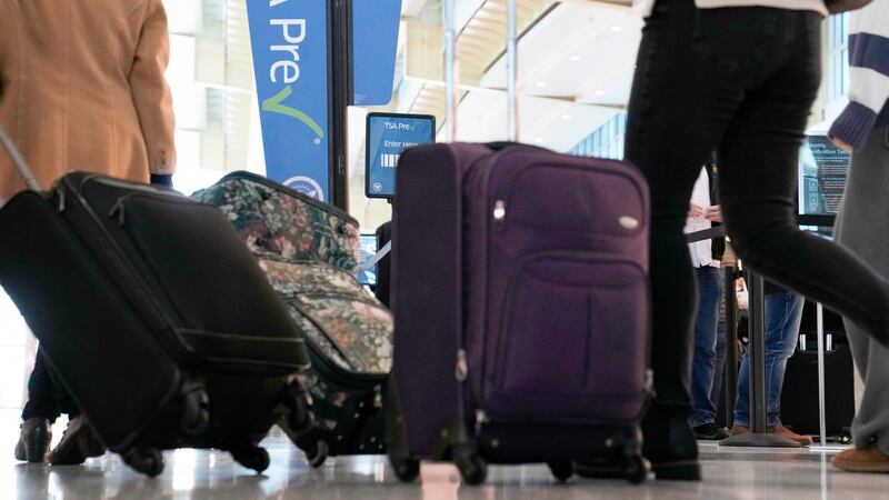 FILE - As the Thanksgiving holiday approaches, travelers walk through Reagan Washington...