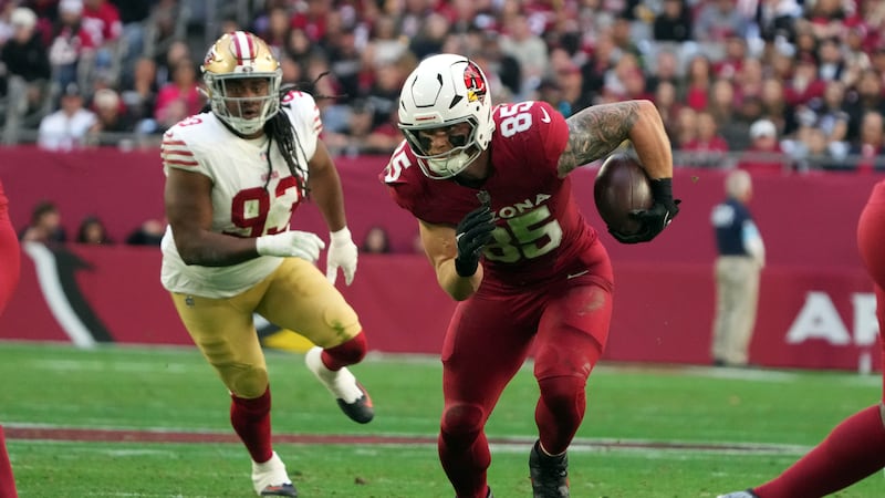 Arizona Cardinals tight end Trey McBride (85) runs past San Francisco 49ers defensive tackle...