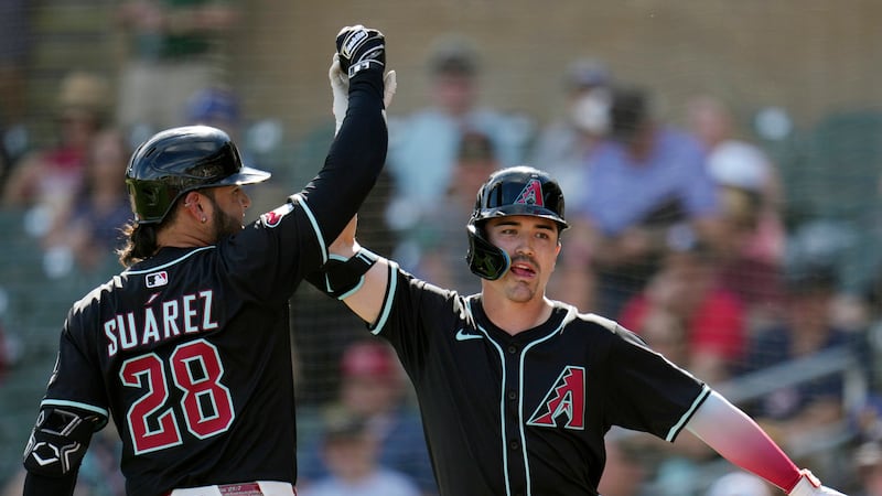 Arizona Diamondbacks' Corbin Carroll, right, celebrates after his home run against the...