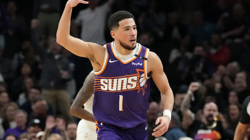 Phoenix Suns guard Devin Booker celebrates his 3-pointer against the Minnesota Timberwolves...