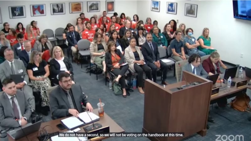 The audience looked on as the board decided to not vote on the handbook.
