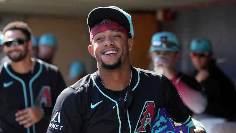 Arizona Diamondbacks second baseman Ketel Marte smiles as he walks through the dugout prior to...
