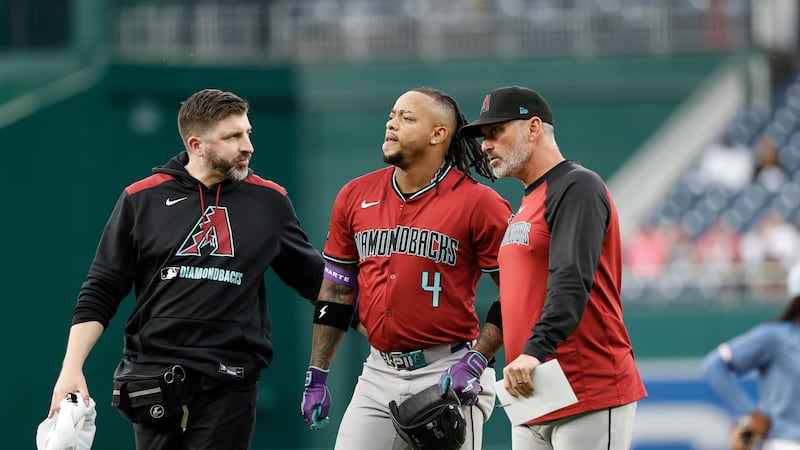Arizona Diamondbacks' Ketel Marte (4) is seen by the trainer and manager Torey Lovullo after...